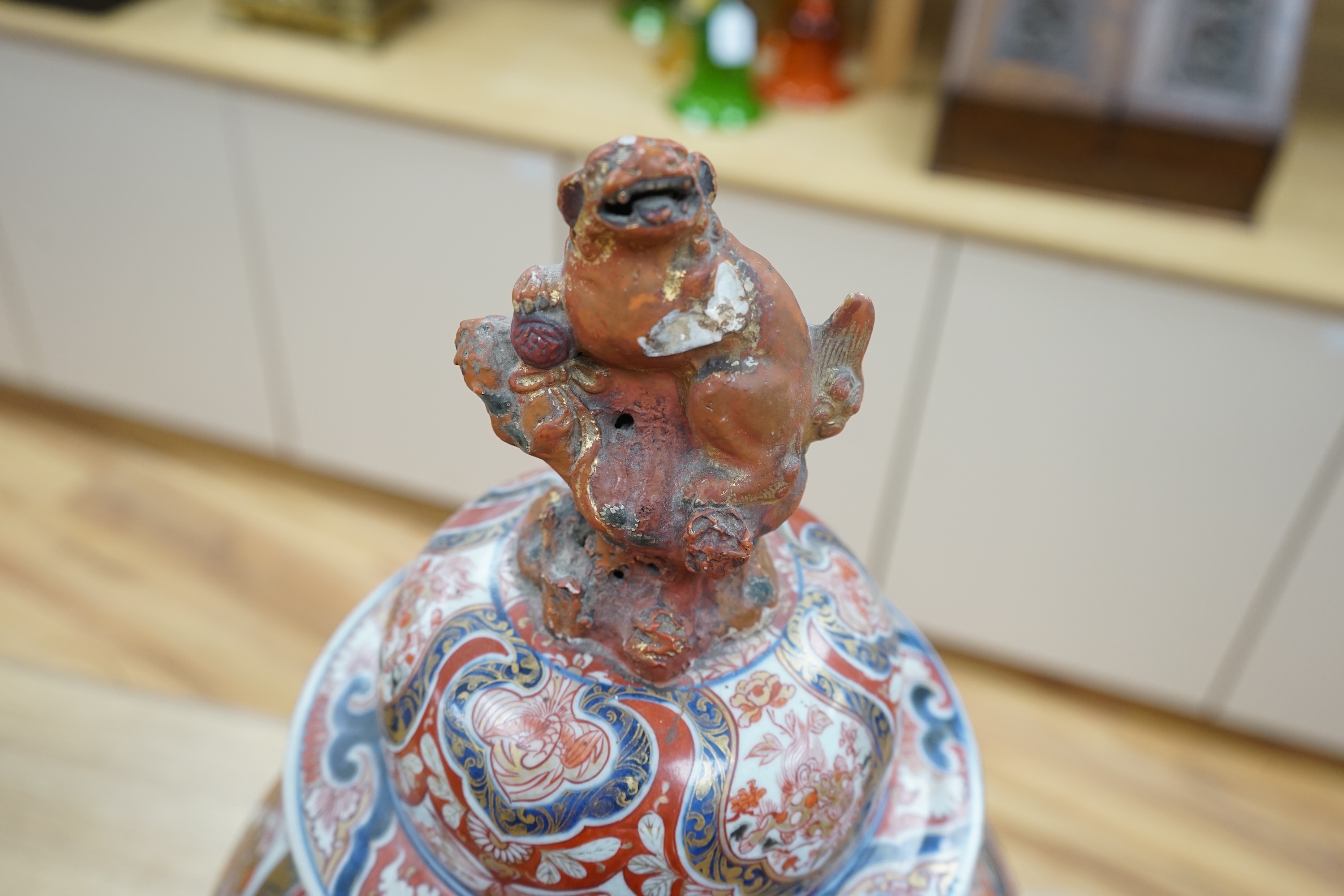 A large 19th century Imari vase with dragon finial to cover, 61cm high. Condition - badly cracked and restored